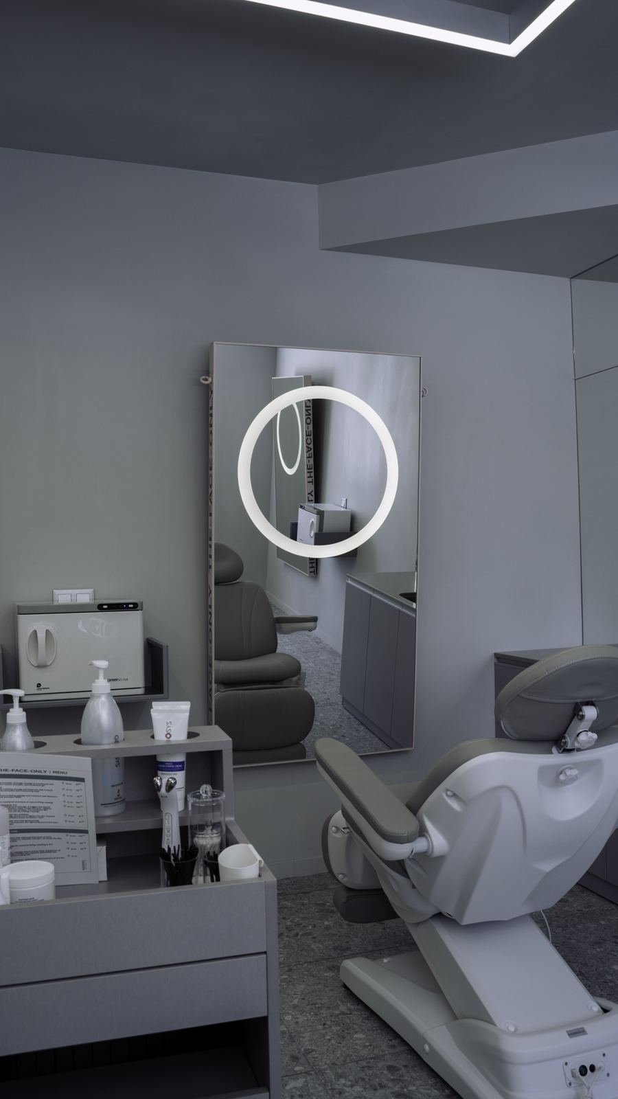 Treatment room with backlit mirror