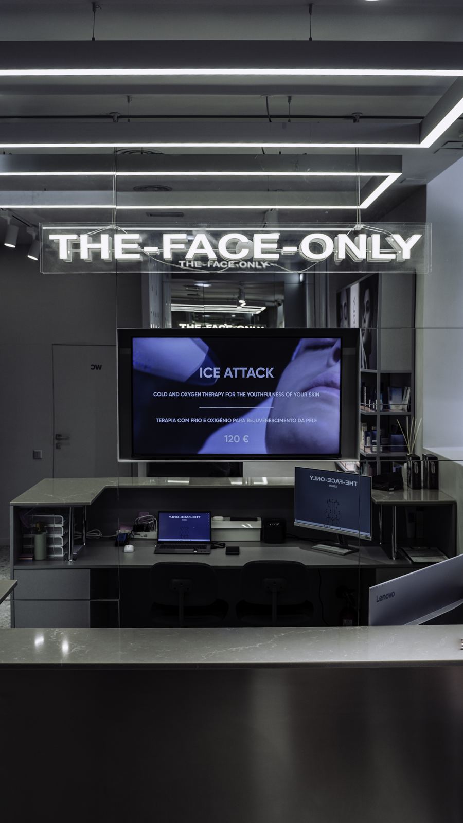 Reception desk under the brand sign, The Face Only