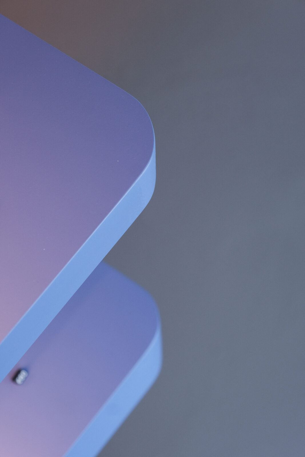 Rounded edge of a blue painted shelf, Pause